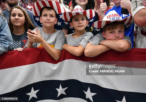 Supporters of the US president and children wearing "Trump 2020" hats attend a rally at the Monroe Civic Center in Monroe, Louisiana on November 6,...