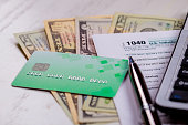 1040 individual tax return and US dollar banknotes cash credit cards