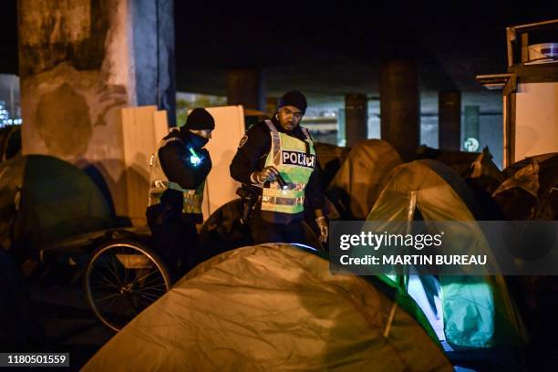 Migrants are evacuated by French police and Gendarmerie in Paris on November 7, 2019. More than a thousand migrants and homeless have settled camp in...
