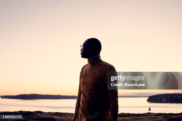 portrait of young man at sunset - black silhouette stock pictures, royalty-free photos & images