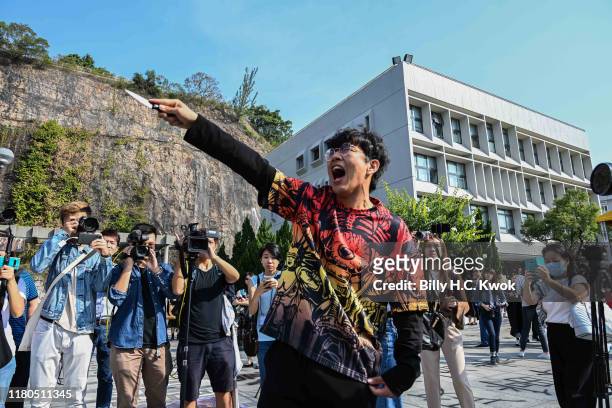 Mainland student holds a knife and shouts before the congregation ceremony at the Chinese University of Hong Kong on November 07, 2019 in Hong Kong,...