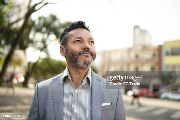 businessman looking away on the street - looking away stock pictures, royalty-free photos & images