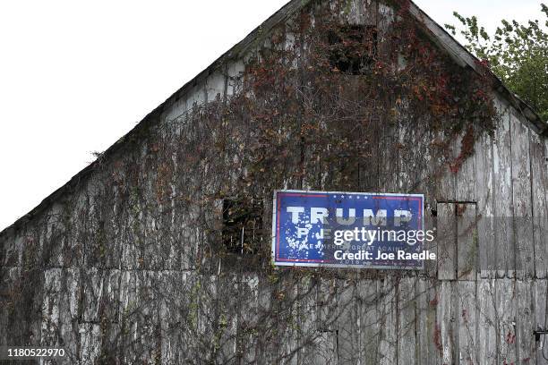 Trump-Pence political sign from 2016 is seen attached to the side of a barn on October 11, 2019 in Newton, Iowa. The 2020 Iowa Democratic caucuses...