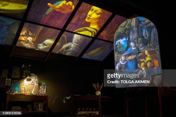 Projection of the painting, 'The Virgin of the Rocks' by Leonardo da Vinci is seen in a reimagined studio room during a photocall for the upcoming...