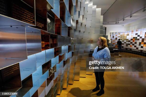 Gallery workers pose during a photocall for the upcoming 'Leonardo: Experience a Masterpiece' exhibition at the National Gallery in London on...