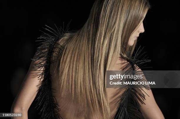 Model presents a creation by Agua de Coco during the 2010-2011 Spring-Summer collections of the Sao Paulo Fashion Week, in Sao Paulo, Brazil, on June...