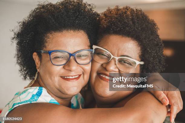 happy sisters - black hair stock pictures, royalty-free photos & images