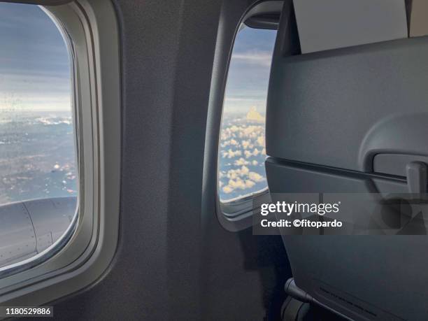 seats and windows of an airplane at flight - airplane seats stock pictures, royalty-free photos & images