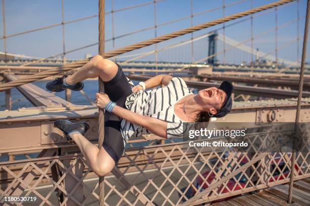 woman performing gymnastics on a bridge she is happy - ポールダンサー ストックフォトと画像