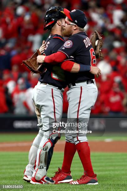 Yan Gomes and Sean Doolittle of the Washington Nationals celebrate their teams 2-0 win over the St. Louis Cardinals in game one of the National...