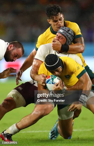 Matt Toomua grabs Beka Gorgadze o Georgia who in turn tackles Christian Lealiifano of Australia during the Rugby World Cup 2019 Group D game between...