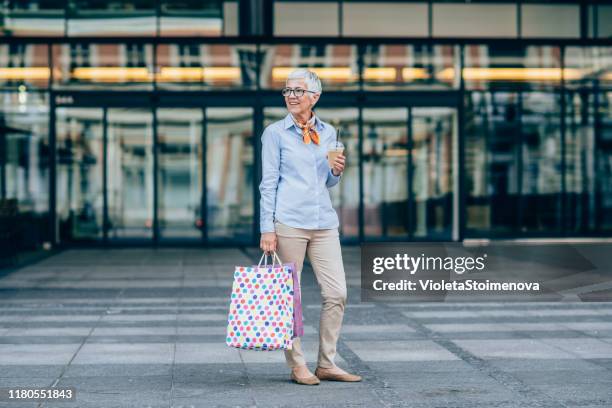 beautiful mature woman shopping - senior women shopping stock pictures, royalty-free photos & images
