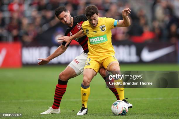 Tommy Oar of the Mariners competes with Dylan McGowan of the Wanderers during the round one A-League match between the Western Sydney Wanderers and...