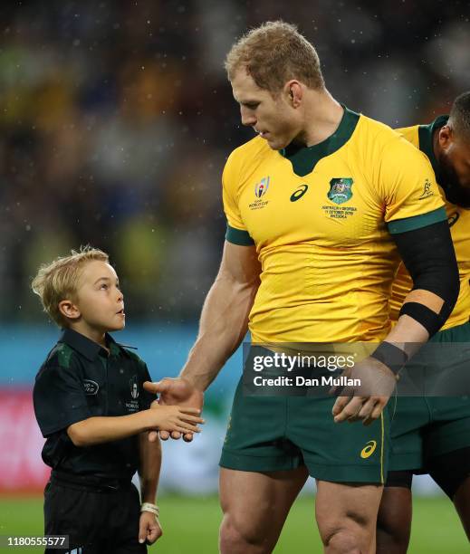 David Pocock of Australia shakes hands with the match mascot during the Rugby World Cup 2019 Group D match between Australia and Georgia at Shizuoka...