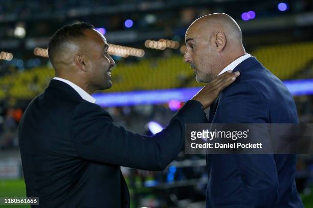Past Victory player Archie Thompson speaks with past Victory head coach Kevin Muscat ahead of the round one A-League match between the Melbourne...