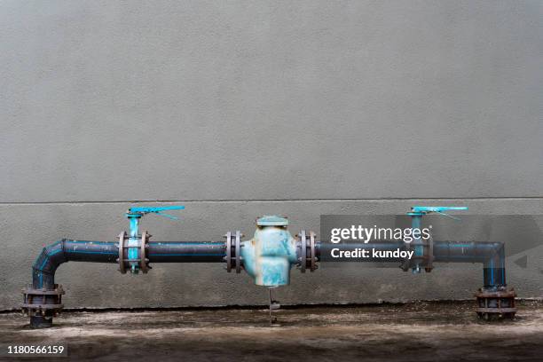 water pipes and valves outside on the wall with free space background. - water pump ストックフォトと画像