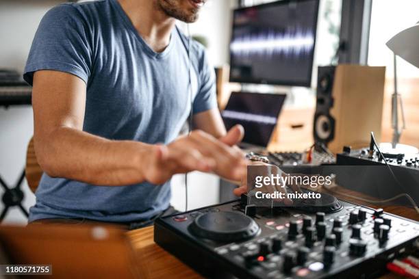 dj working on sound mixer at home recording studio - dj table stock pictures, royalty-free photos & images