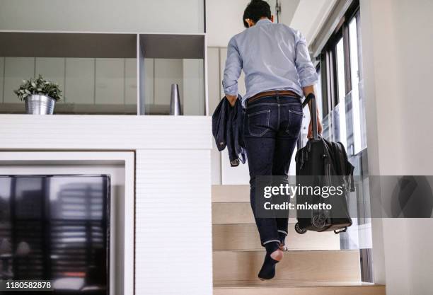 businessman arriving in hotel - bachelor apartment stock pictures, royalty-free photos & images