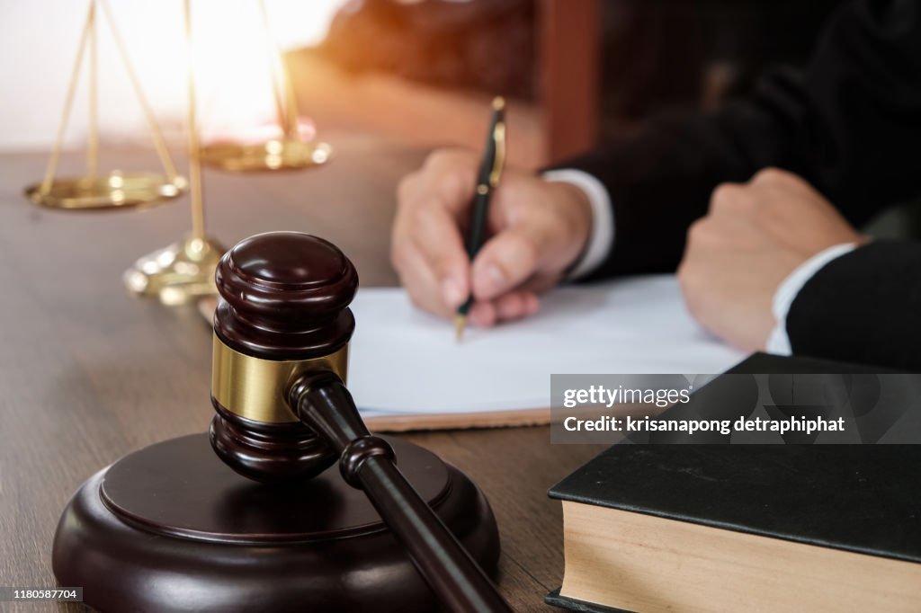 Law, lawyer attorney and justice concept, male lawyer or notary working on a documents and report of the important case in the law firm,bangkok,thailand