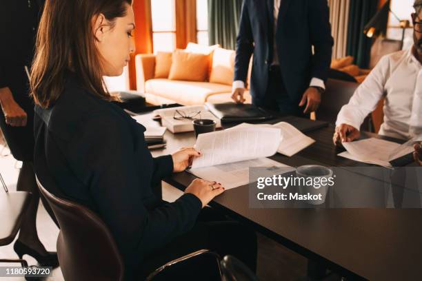 female-lawyer-reading-document-while-sitting-with-colleagues-in-board-room-at-office.jpg?s=612x612u0026w=giu0026k=20u0026c=C24vUKM39t6MZzqF4KdSHBALcHz2rZI59PRQSQNm2l0=