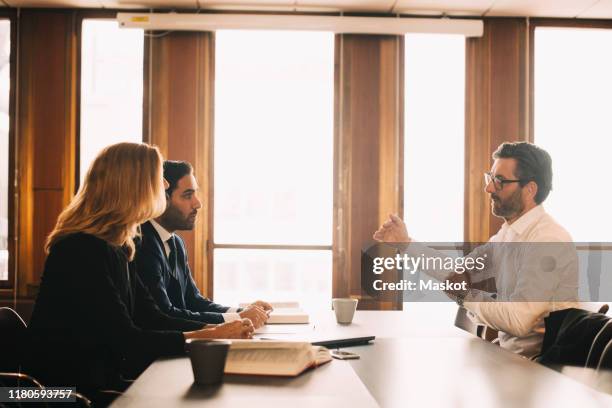 businessman explaining problems to lawyers in meeting at office - judiciary hearing stock pictures, royalty-free photos & images