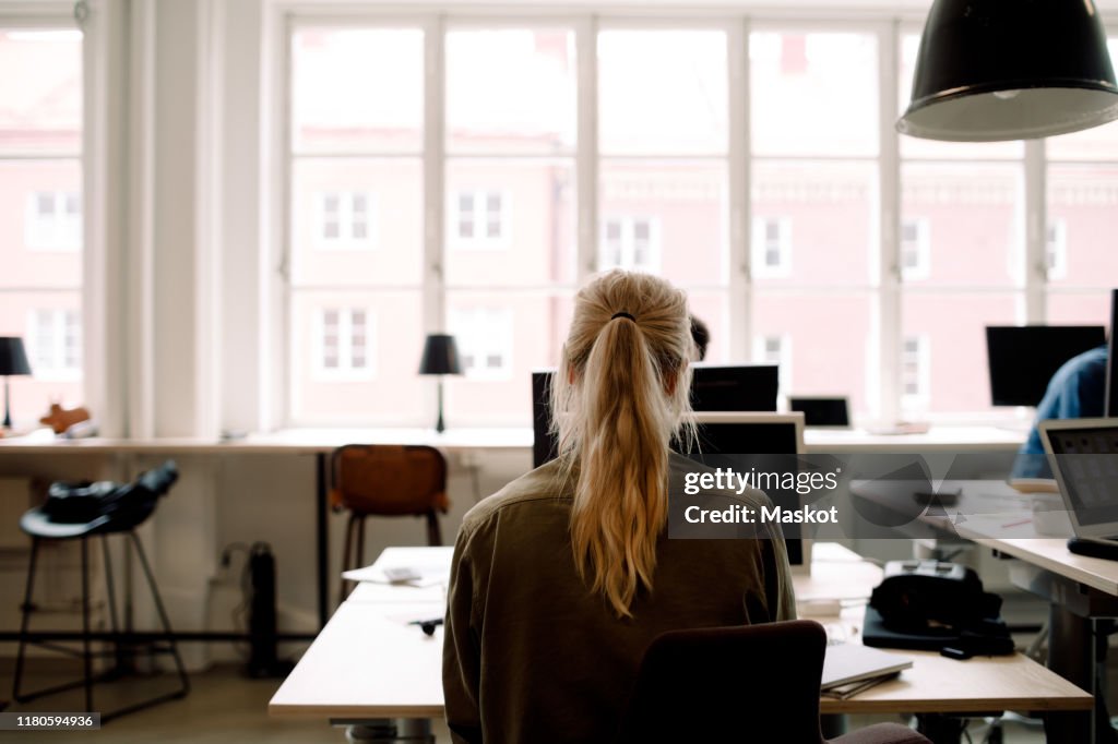 Rear view of businesswoman working in creative office