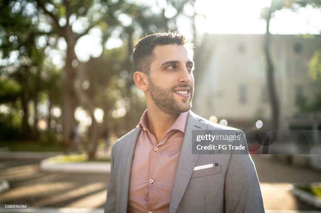 Young businessman looking away on the street