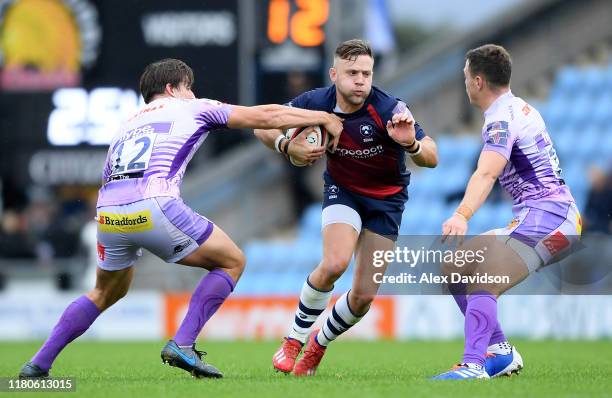 Ian Madigan of Bristol Bears attempts to get past Joe Simmonds and Tom Hendrickson of Exeter Chiefs during the Premiership Rugby Cup Fourth Round...