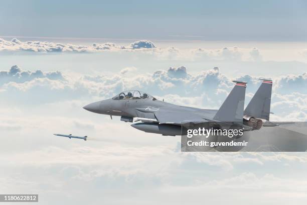 f-15 strike eagle fighter plane firing missile - fighter plane stock pictures, royalty-free photos & images