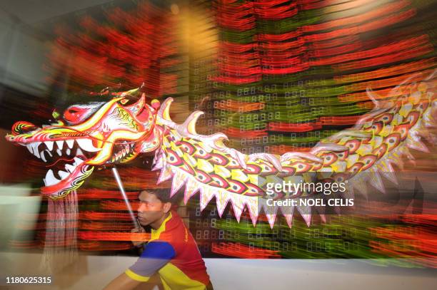 Filipinos perform a dragon dance to celebrate the Chinese Lunar New Year on the trading floor of the Philippine Stock Exchange in Manila on January...
