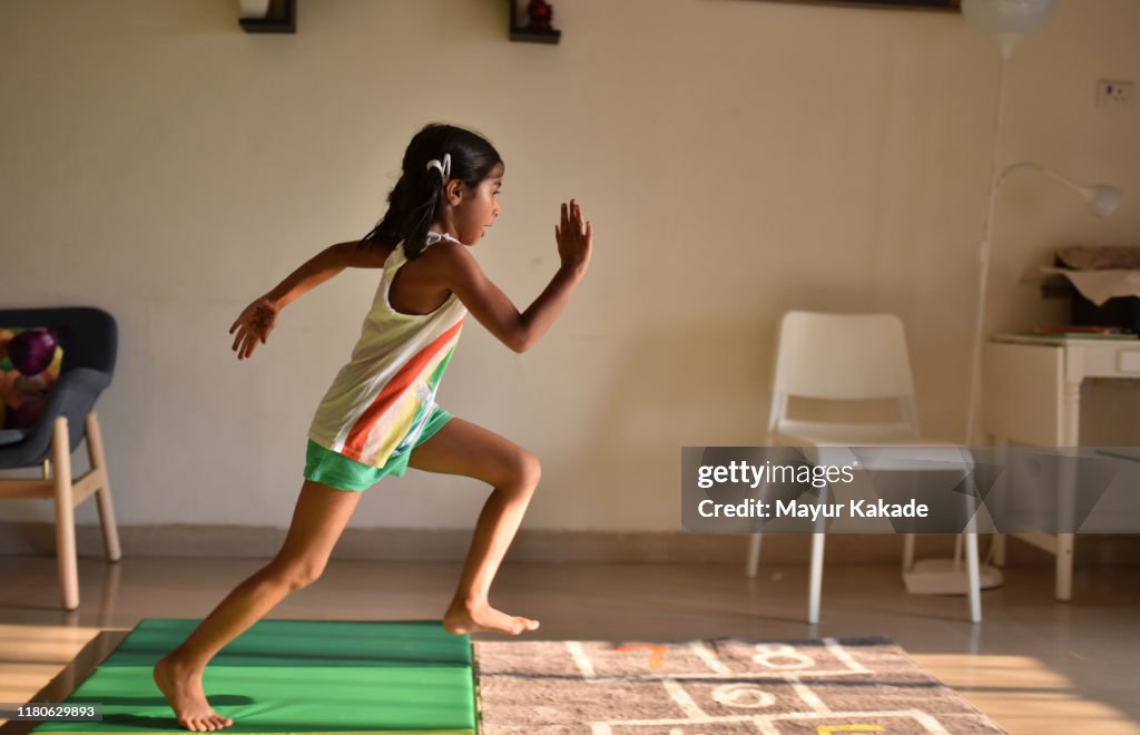Girl displaying her athletics skills at home