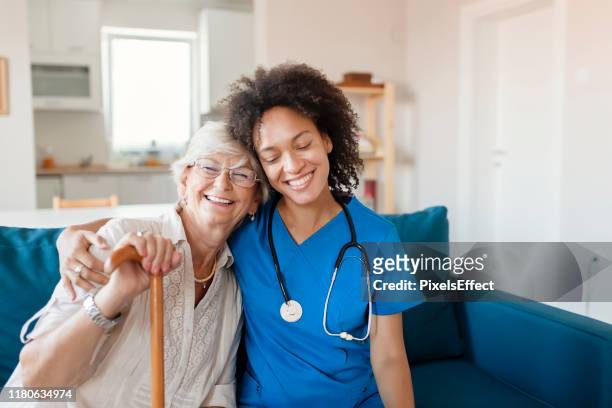 portret van senior vrouw en haar gemengde ras vrouwelijke verzorger - caregiver and senior stockfoto's en -beelden