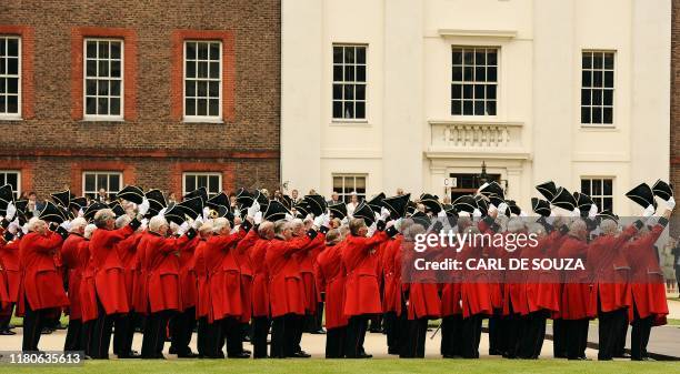 Chelsea Pensioners raise their hats towards Britain's Prince Harry during the annual Founders Day Parade at the Royal Hospital Chelsea, in London, on...