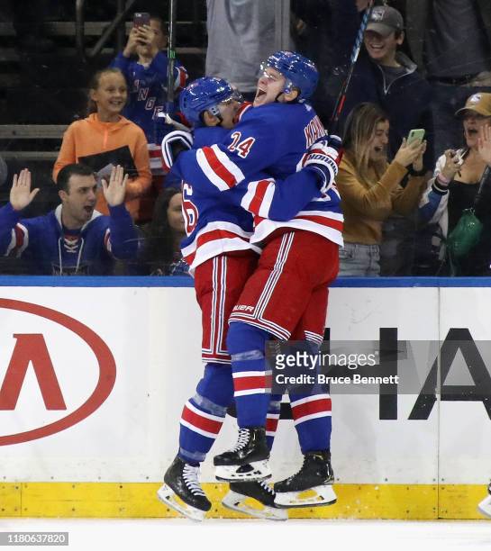 Kaapo Kakko of the New York Rangers celebrates his first NHL goal at 18:28 of the first period against the Edmonton Oilers as he is embraced by Ryan...