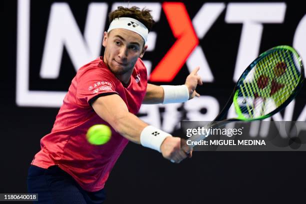 Norway's Casper Ruud returns a backhand to Australia's Alex De Minaur on November 7, 2019 during their group stage match of the Next Generation ATP...