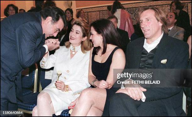 Balmain President Alain Hivelin greets French actress Catherine Deneuve, accompanied by his Daughter, Miss Hivelin, and French actor Gerard...