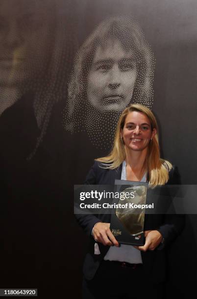 Nia Kuenzer poses with the award during the Hall Of Fame gala at Deutsches Fussballmuseum on October 12, 2019 in Dortmund, Germany.