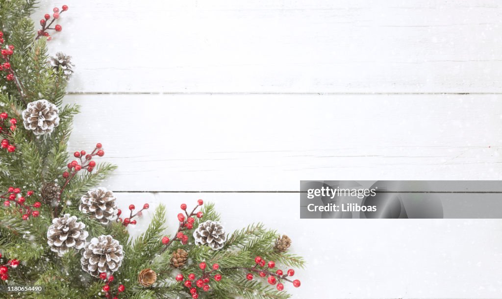 Christmas pine garland border on an old white wood background