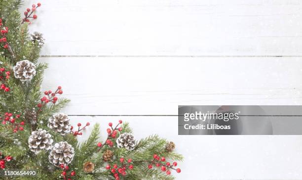 christmas pine garland border on an old white wood background - composition stock pictures, royalty-free photos & images