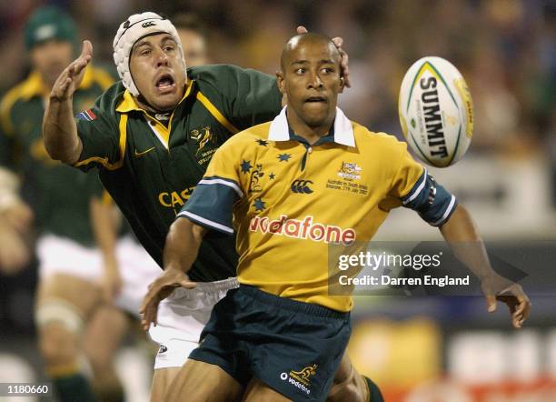 George Gregan of the Wallabies is tackled by De Wet Barry of the Springboks during the Tri Nations Rugby Union test match between Australia and South...