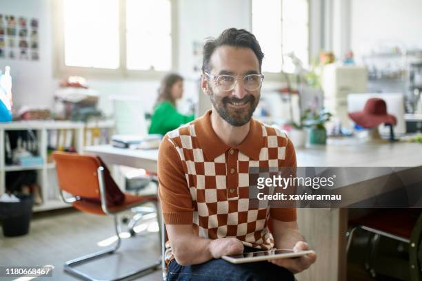portrait of spanish design professional using digital tablet - persons with disabilities stock pictures, royalty-free photos & images