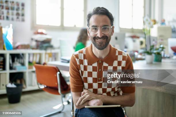 portrait of smiling spanish design professional in studio - physical disability stock pictures, royalty-free photos & images
