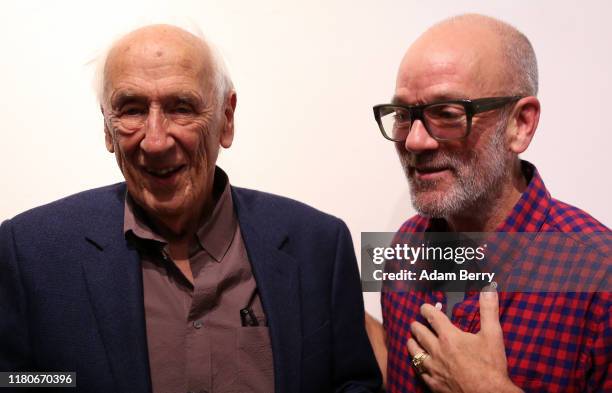 German photographer Thomas Höpker , and Michael Stipe, former singer of the band R.E.M., speak to one another as they attend a presentation of...