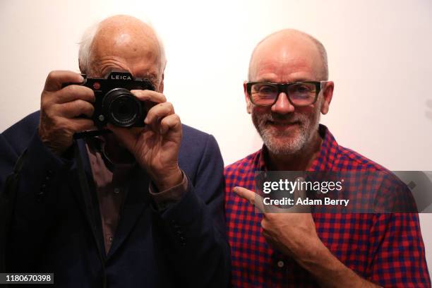 German photographer Thomas Höpker , and Michael Stipe, former singer of the band R.E.M., speak to one another as they attend a presentation of...