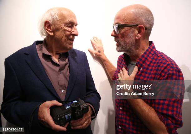 German photographer Thomas Höpker , and Michael Stipe, former singer of the band R.E.M., speak to one another as they attend a presentation of...