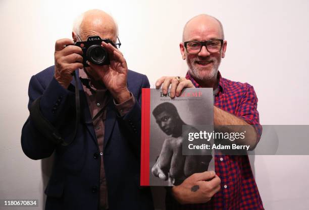 Michael Stipe, former singer of the band R.E.M. , holds a book of photos of Muhammad Ali by German photographer Thomas Höpker called "Big Champ" as...