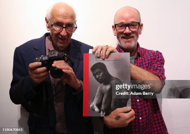 Michael Stipe, former singer of the band R.E.M. , holds a book of photos of Muhammad Ali by German photographer Thomas Höpker called "Big Champ" as...