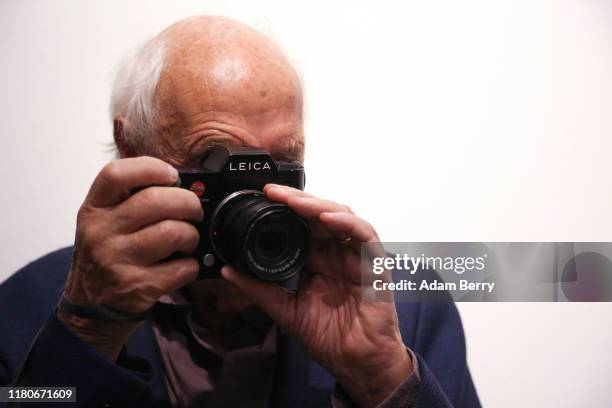 Photographer Thomas Höpker takes a photo with a Leica camera as he attends a presentation of Former R.E.M. Singer Michael Stipe's photo book "Our...