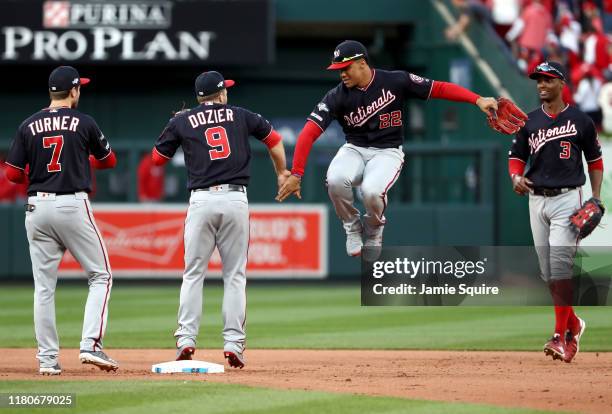 Juan Soto, Brian Dozier, Trea Turner and Michael A. Taylor of the Washington Nationals celebrate after the final out to defeat the St. Louis...