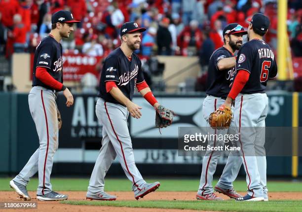 Adam Eaton, Anthony Rendon, Brian Dozier and Trea Turner of the Washington Nationals celebrate after the final out to defeat the St. Louis Cardinals...